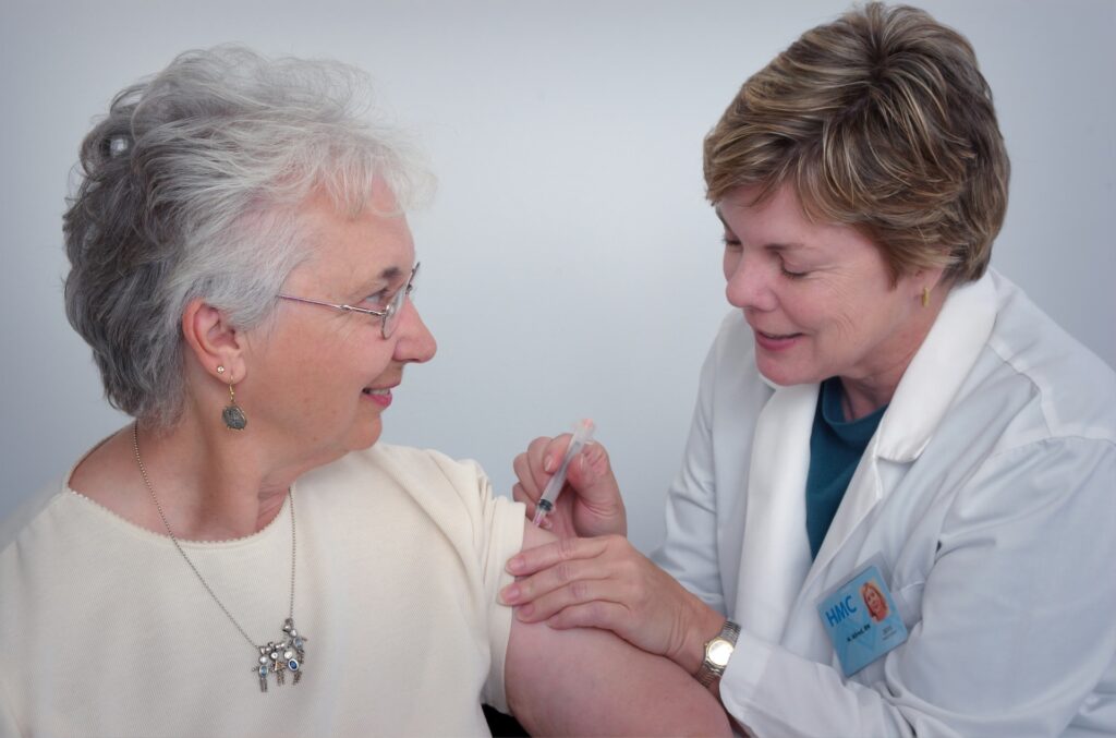 Female doctor giving a female patience an injection.part of the women's healthcare