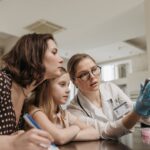 a female doctor explaining information to a mother and her daughter to make smarter choices