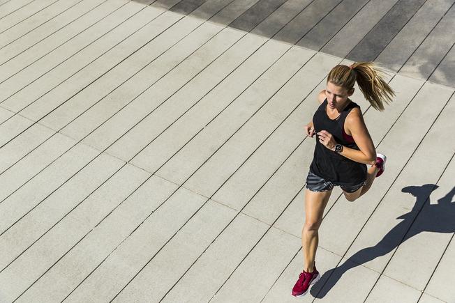 a woman is jogging to prioritize health