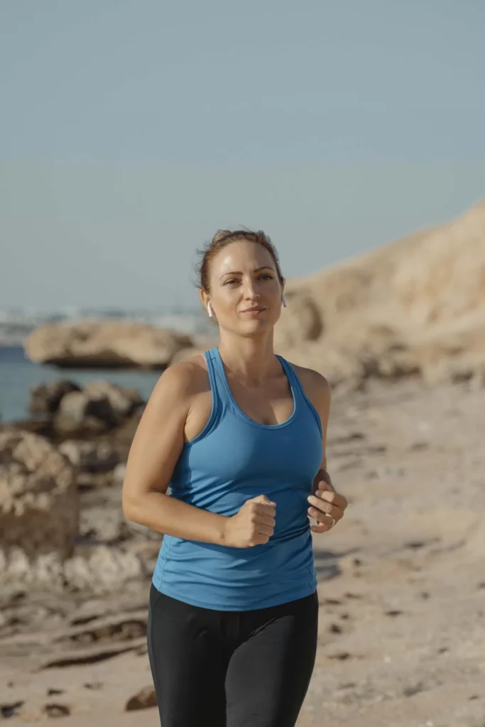 Woman jogging at the beach to unlock health and wellness