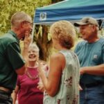 four seniors outside talking laughing and enjoying their golden years