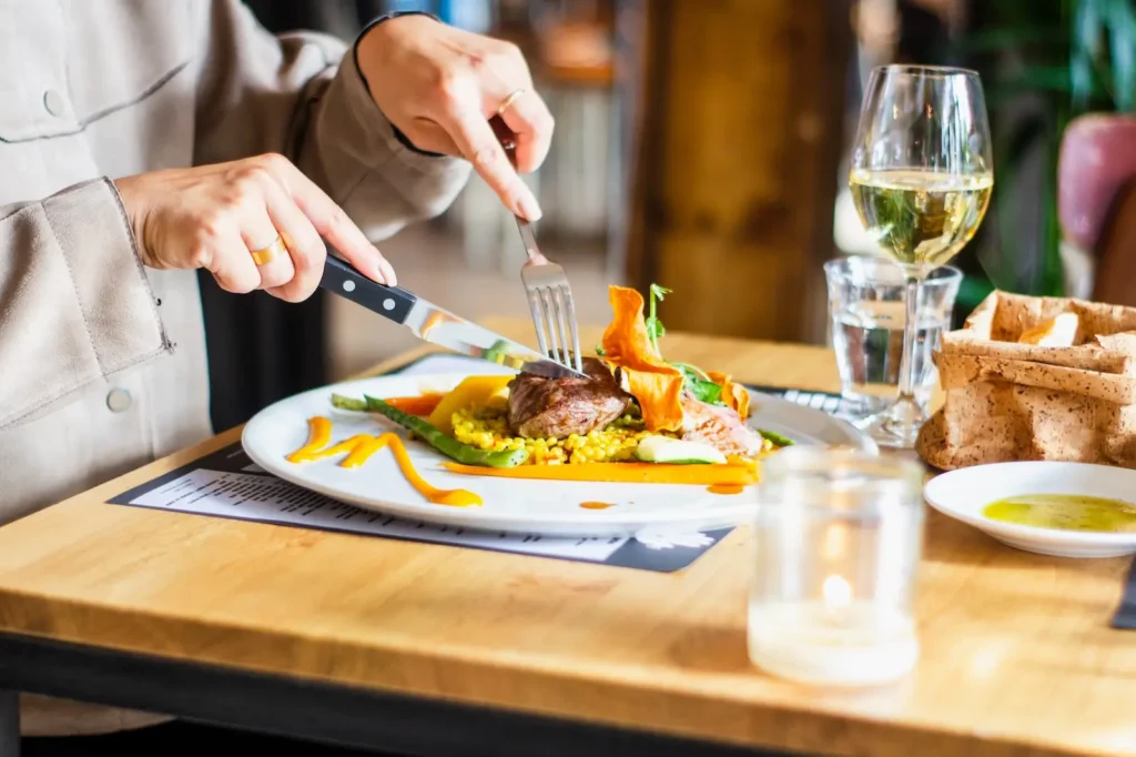 a person at the dinner table practicing healthy eating during a meal