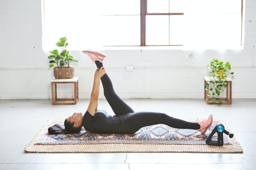 a women doing leg lifts one of the best health and wellness exercises you can do
