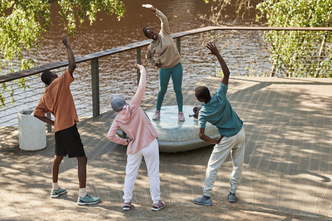 four people outside byba lake exercising
