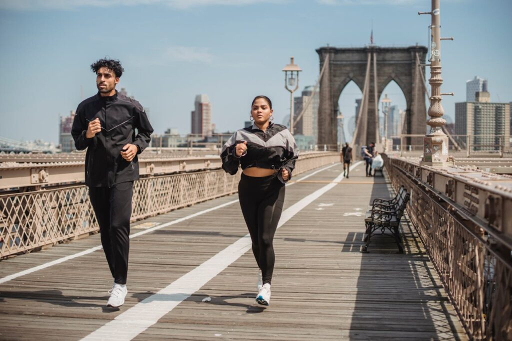 two people jogging across a bridge balancing body and mind