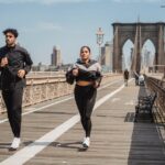 two people jogging across a bridge balancing body and mind