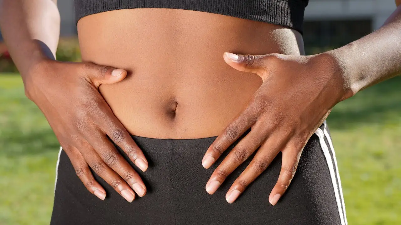 a woman holding her stomach representing gut health importance