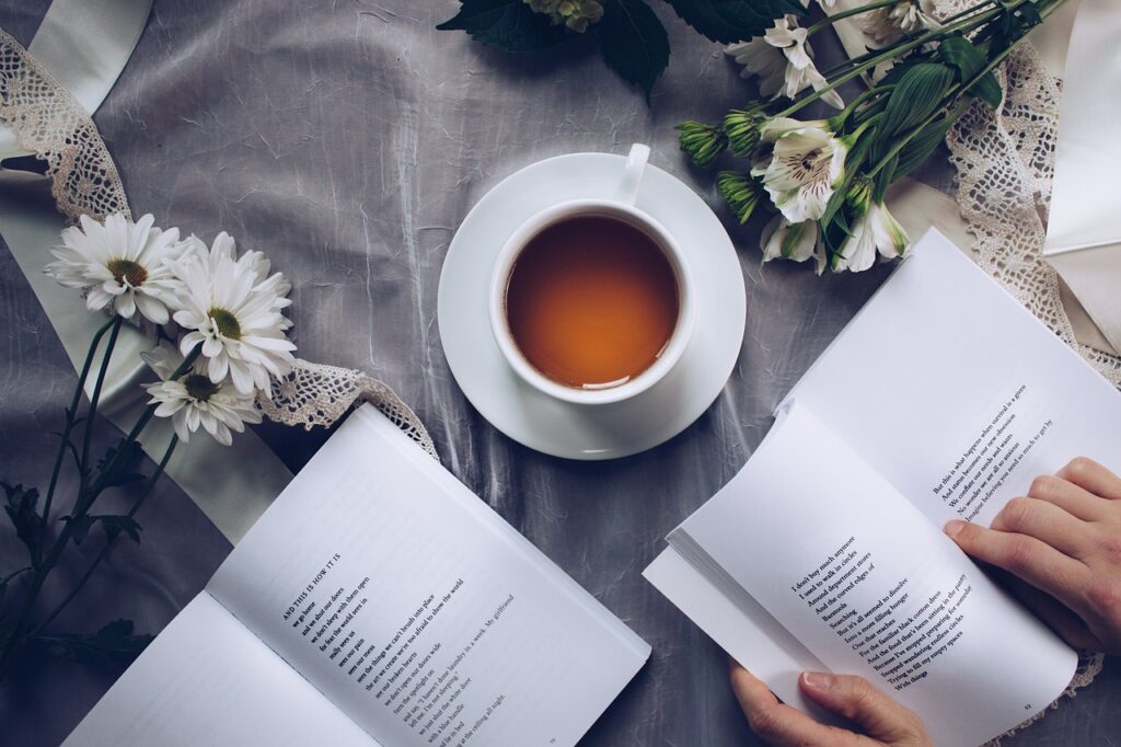 two of the best health and wellness books opened on a gray table cloth with daisies